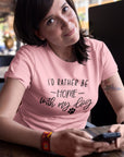 id-rather-be-home-with-my-dog-pink-t-shirt-animal-lover-woman-wearing-a-t-shirt-template-while-at-a-coffee-shop-checking-her-phone