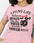 living-life-between-jesus-take-the-wheel-and-i-wish-a-heifer-would-pink-t-shirt-bella-canvas-tee-mockup-featuring-a-smiling-woman-with-curly-hair