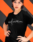 love-black-t-shirt-womens-mockup-featuring-a-woman-standing-in-front-of-a-patterned-wall