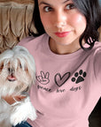 peace-love-dogs-pink-t-shirt-mockup-of-a-pretty-woman-wearing-a-round-neck-tee-while-taking-a-selfie-with-her-dog