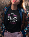 real-bitches-catch-fishes-black-t-shirt-fishing-pretty-girl-wearing-a-round-neck-t-shirt-mockup-while-outdoors
