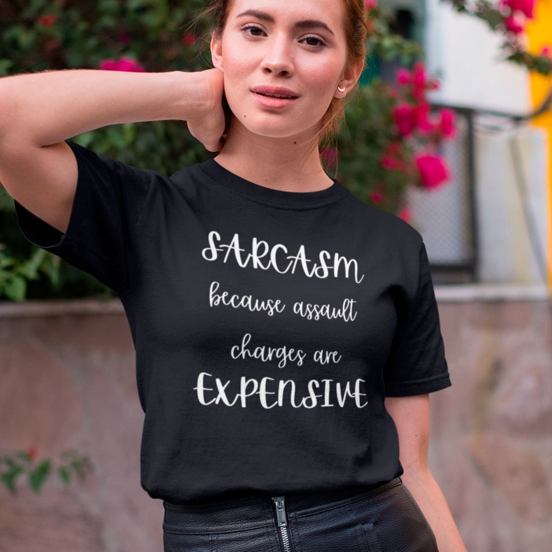 sarcasm-because-assault-charges-are-expensive-black-t-shirt-women-funny-tee-mockup-of-a-girl-in-a-leather-skirt-posing-by-a-street-with-flowers