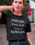 sarcasm-because-assault-charges-are-expensive-black-t-shirt-women-funny-tee-mockup-of-a-girl-in-a-leather-skirt-posing-by-a-street-with-flowers