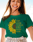 take-every-chance-drop-every-fear-heather-kelly-green-t-shirt-sunflower-mockup-featuring-a-smiling-woman-posing-on-a-yacht