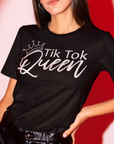 tik-tok-queen-black-t-shirt-womens-mockup-featuring-a-fashionable-woman-posing-in-a-red-light-studio