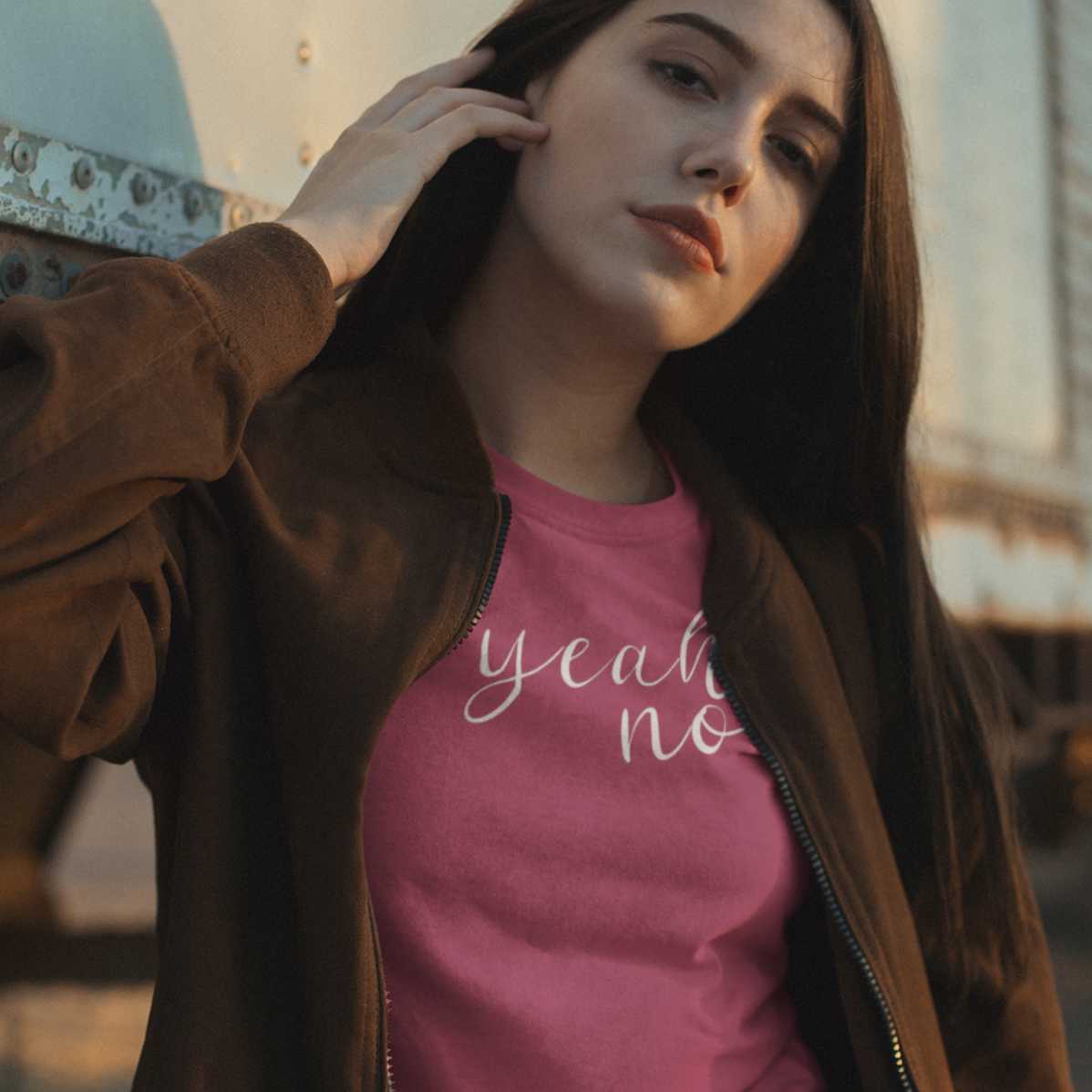yeah-no-berry-t-shirt-womens-mockup-of-a-girl-wearing-a-t-shirt-and-a-vintage-bomber-jacket-posing-against-a-truck