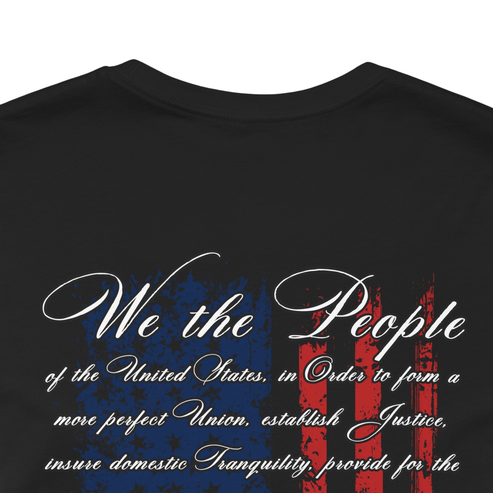 rear view closeup of black  colored fabric patriotic shirt with American flag background and the preamble of the united states constitution on the back pf shirt, front of shirt has americantees.us logo