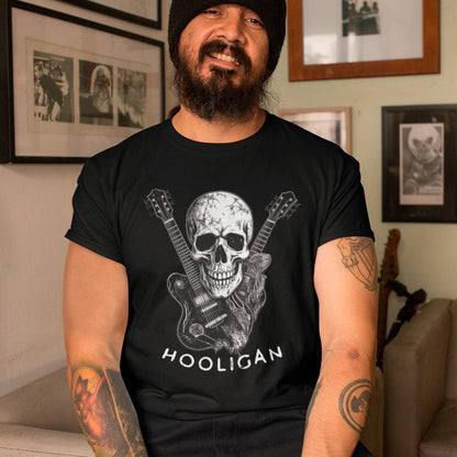 anarchy-strings-punk-black-tee-mockup-of-a-bearded-man-with-tattoos-wearing-a-t-shirt-indoors