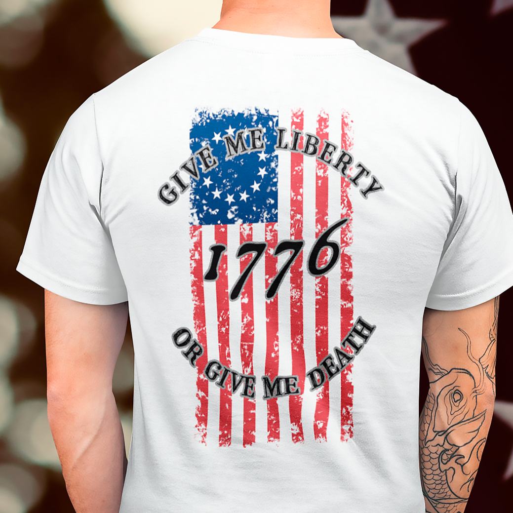 rear view of a a man wearing a white colored fabric shirt with americantees.us logo on front and betsy ross flag with the phrase give me liberty or give me death and 1776 on the back