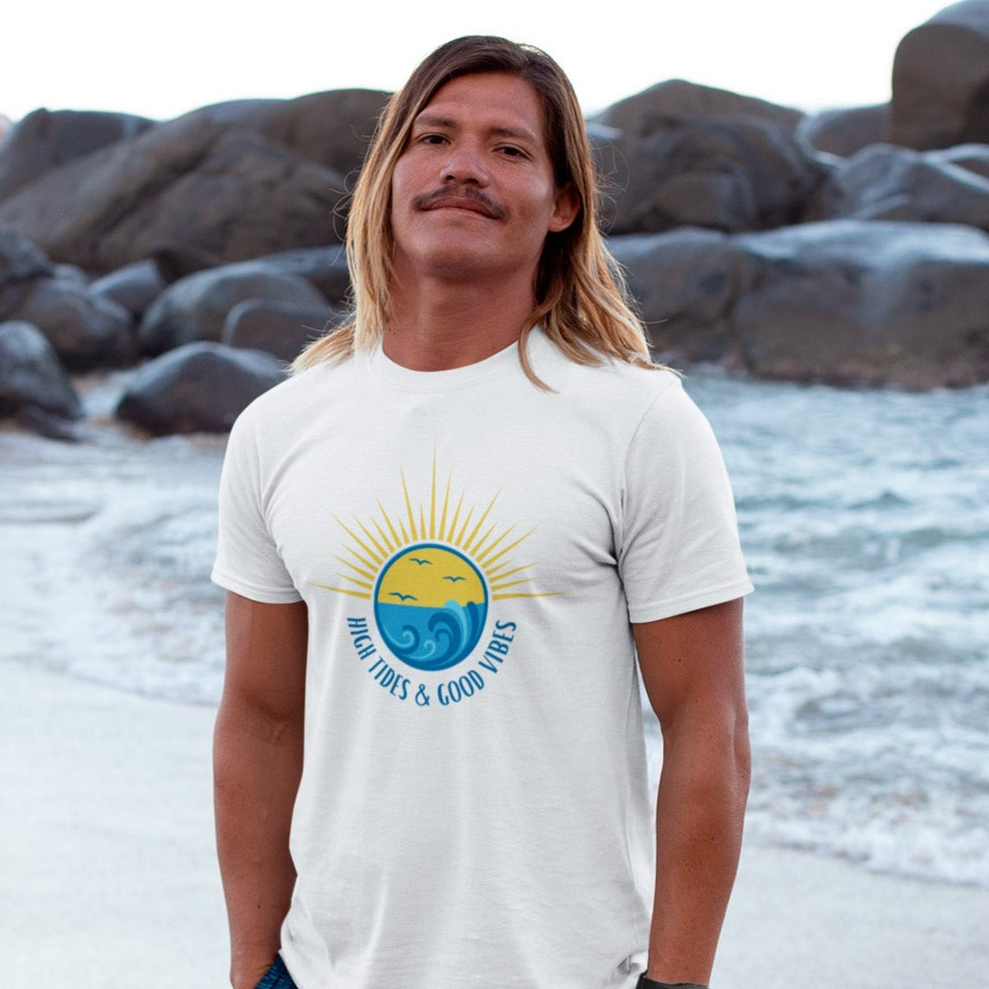 high-tides-and-good-vibes-white-t-shirt-beach-sunset-unisex-mockup-of-a-blonde-long-haired-man-barefoot-at-the-beach