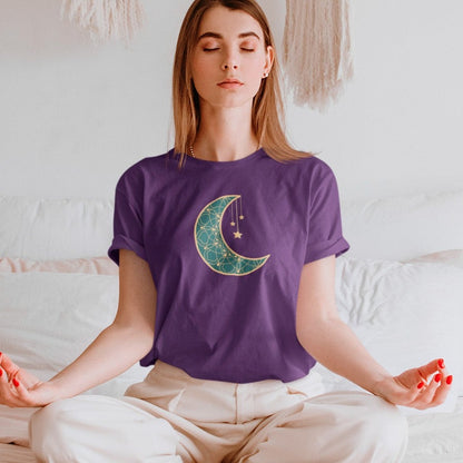 moonlit-charm-team-purple-t-shirt-crescent-moon-with-hanging-stars-mockup-of-a-woman-meditating-in-a-white-bedroom