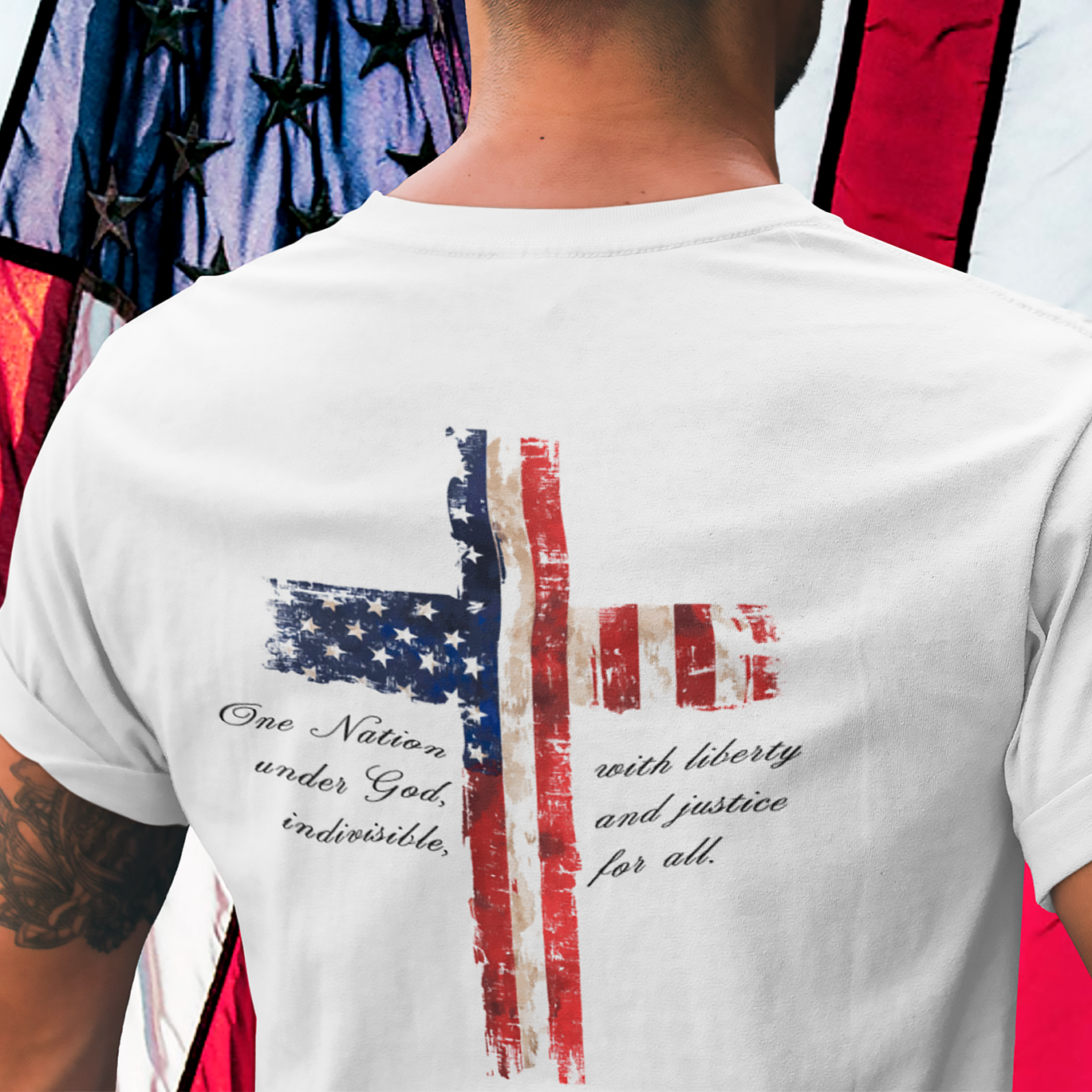rear view of a man wearing a white colored fabric patriotic shirt with American flag in shape of a Christian cross with pledge of allegiance surrounding image