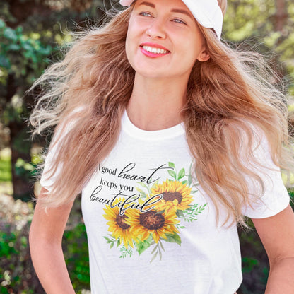 a-good-heart-keeps-you-beautiful-white-t-shirt-womens-sunflower-mockup-of-a-happy-young-woman-strolling-at-a-park