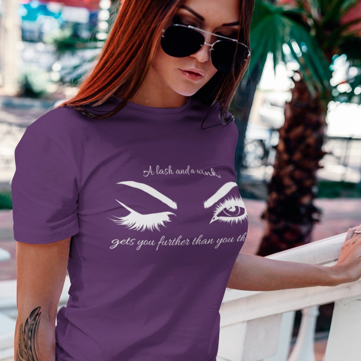 a-lash-and-a-wink-gets-you-further-than-you-think-team-purple-t-shirt-womens-lashes-mockup-featuring-a-tattooed-woman-with-sunglasses