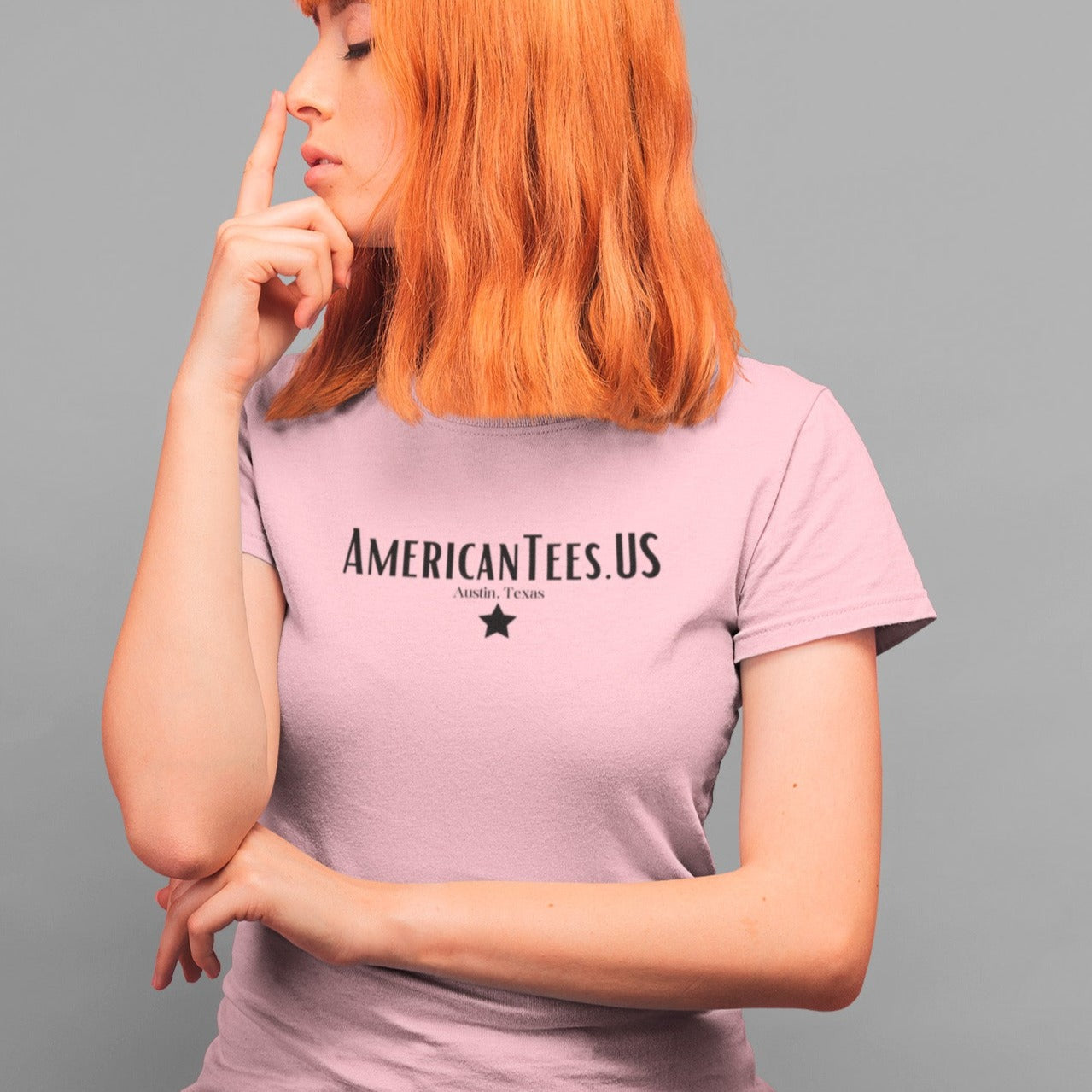 americantees-us-austin-tx-pink-t-shirt-unisex-round-neck-tee-mockup-of-a-redhead-girl-touching-her-nose