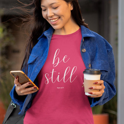 be-still-psalm-46-10-berry-t-shirt-womens-christian-inspiring-bella-canvas-tee-mockup-of-a-woman-checking-her-phone-while-drinking-coffee-on-the-street