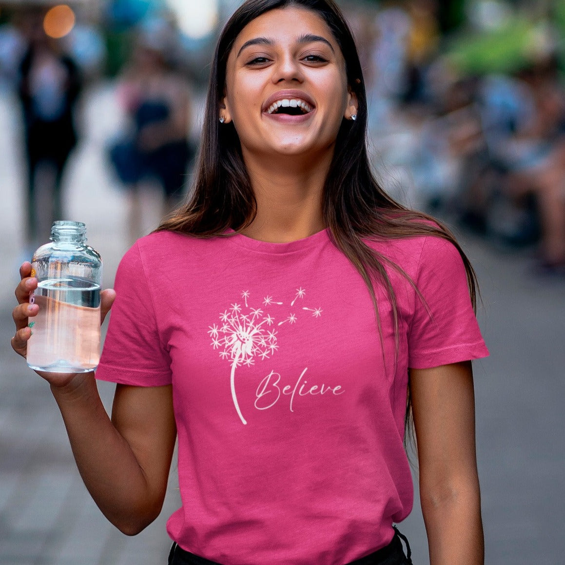 believe-with-dandelion-wishes-berry-t-shirt-womens-inspiring-tee-mockup-of-a-joyful-woman-holding-a-glass-of-water