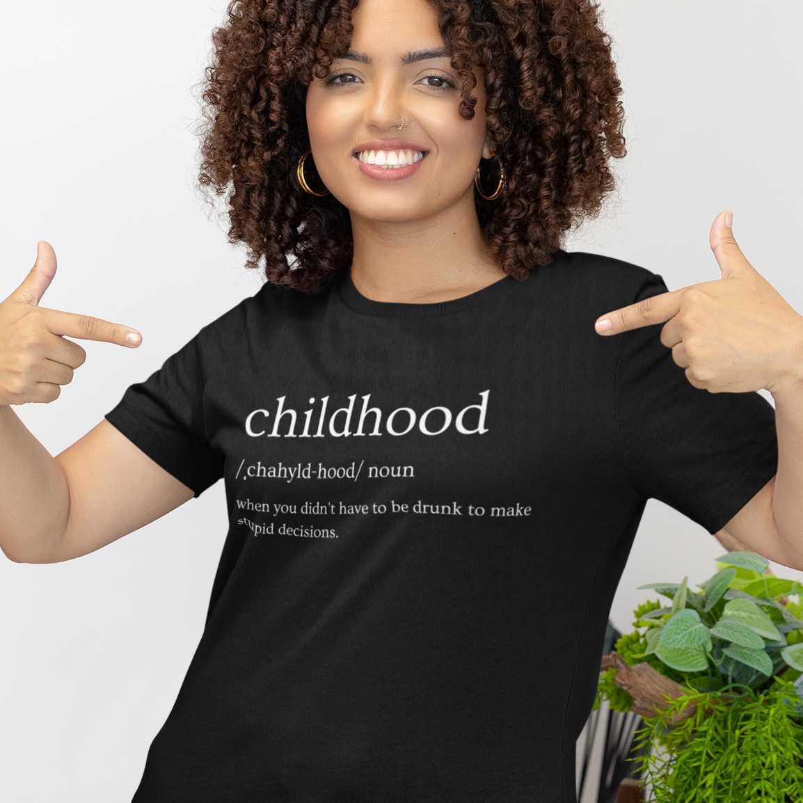 childhood-definition-mockup-featuring-a-woman-pointing-at-her-bella-canvas-t-shirt