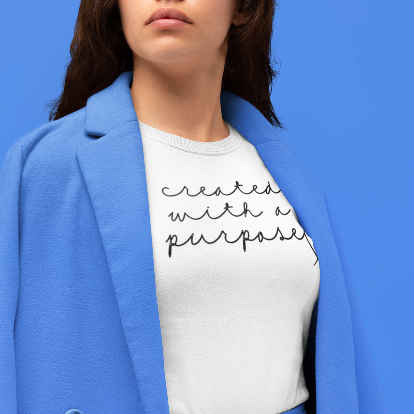 created-with-a-purpose-white-t-shirt-mockup-featuring-a-serious-looking-woman-at-a-studio