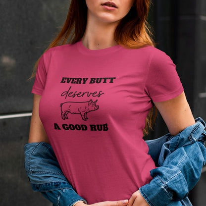 every-butt-deserves-a-good-rub-berry-t-shirt-with-pig-graphic-barbeque-cooking-unisex-mockup-of-a-woman-wearing-a-customizable-crewneck-tee-by-a-dark-wall