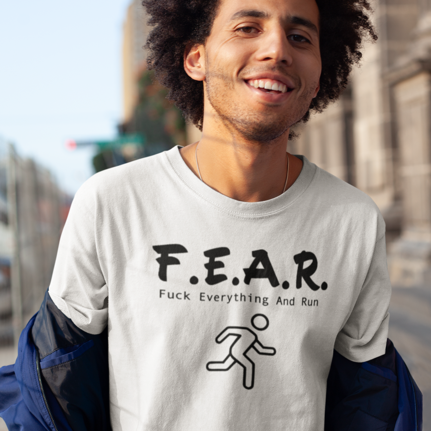 f-e-a-r-t-shirt-mockup-of-a-happy-man-with-an-afro-out-on-the-street-