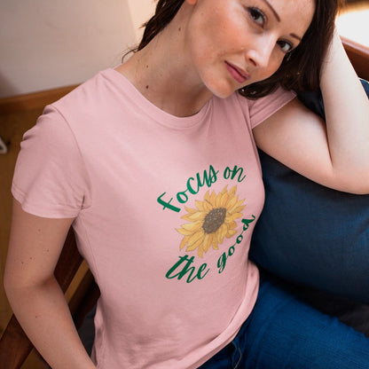 focus-on-the-good-sunflower-pink-t-shirt-womens-hispanic-woman-on-a-chair-wearing-a-tee