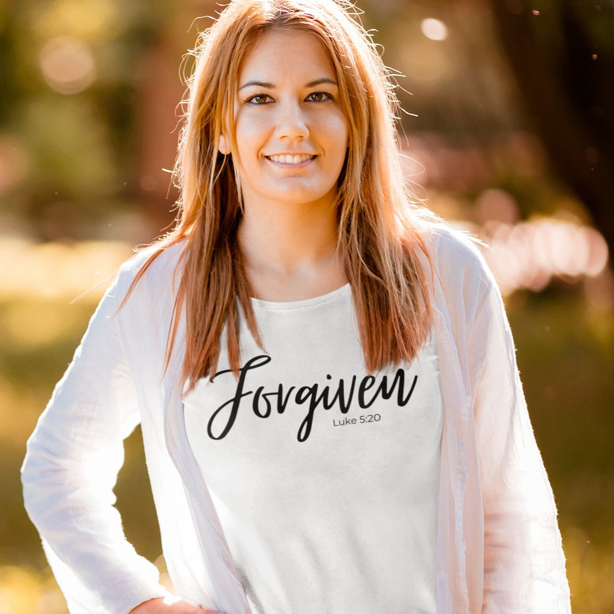 forgiven-luke-5-20-white-t-shirt-unisex-inspiring-christian-mockup-of-a-woman-with-a-basic-tee-posing-in-a-park