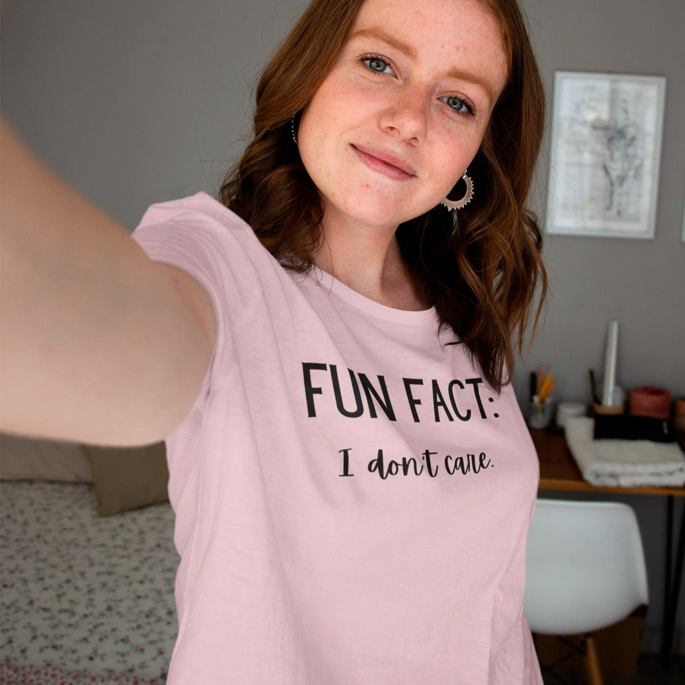 fun-fact-i-dont-care-funny-pink-t-shirt-womens-sarcastic-selfie-mockup-of-a-woman-wearing-a-round-neck-t-shirt-in-her-bedroom