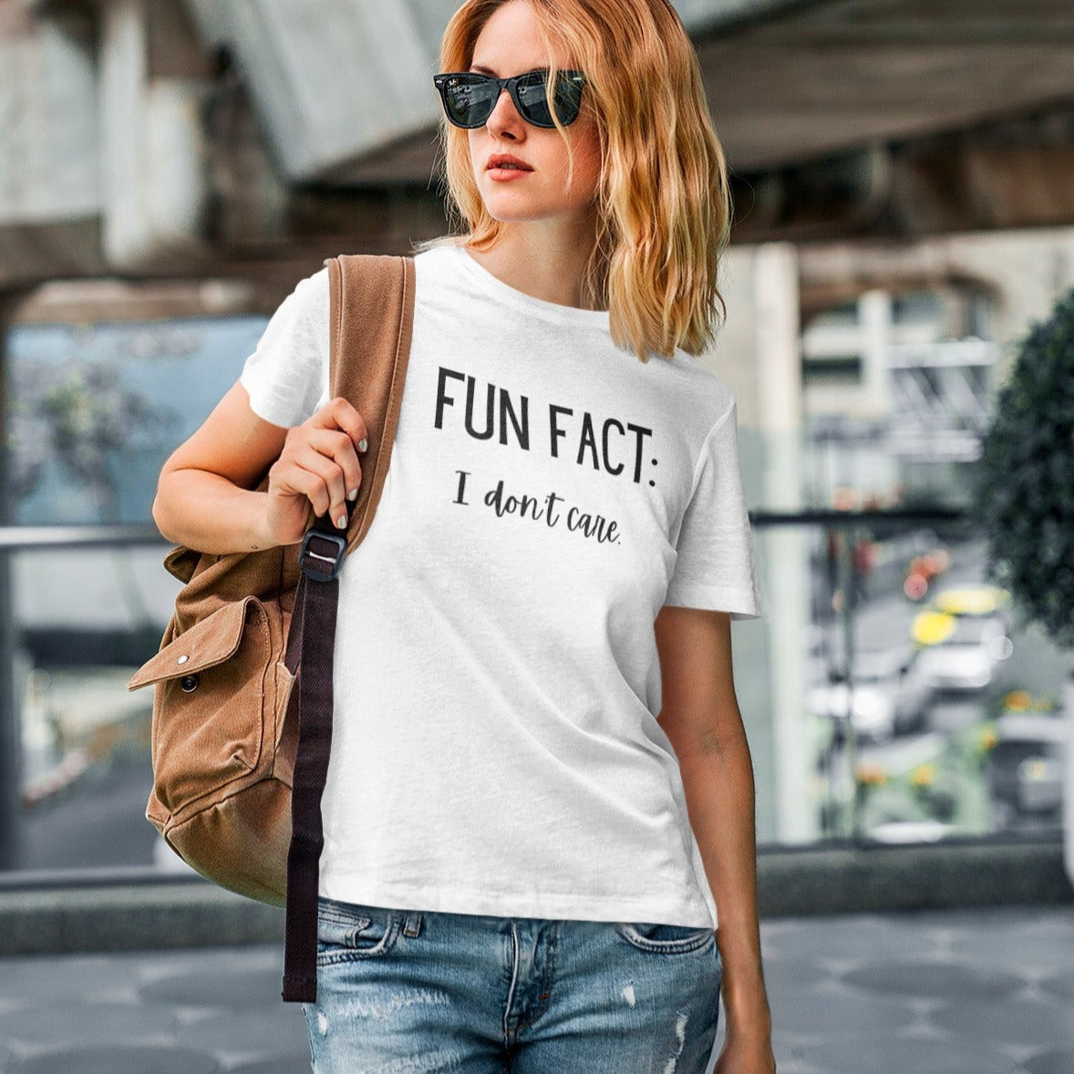 fun-fact-i-dont-care-funny-white-t-shirt-womens-sarcastic-mockup-of-a-woman-wearing-a-round-neck-t-shirt-in-an-urban-setting