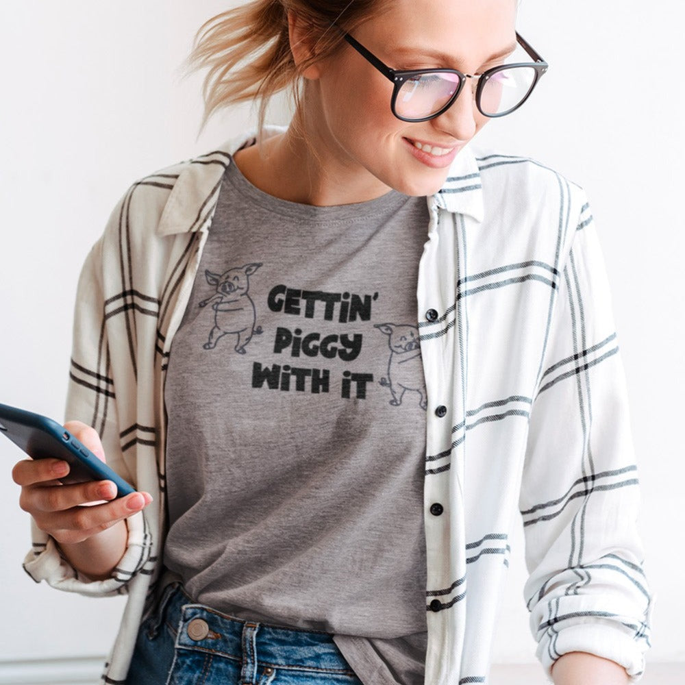 gettin-piggy-with-it-athletic-heather-grey-t-shirt-funny-dancing-pigs-mockup-featuring-a-woman-working