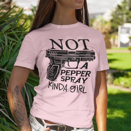 gun-girl-not-a-pepper-spray-kind-of-girl-pink-t-shirt-mockup-of-a-stylish-tattooed-woman-at-a-park