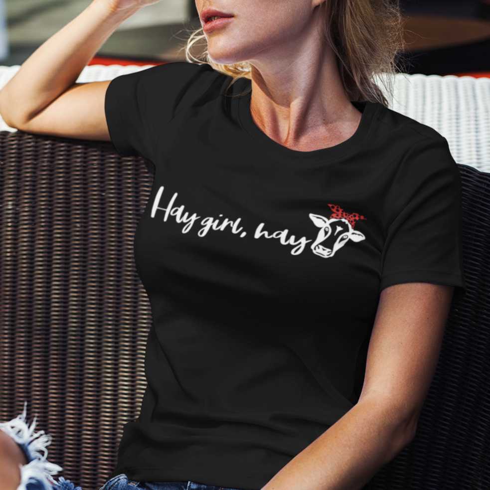 hay-girl-hay-black-t-shirt-cowgirl-womens-mockup-of-a-stylish-woman-sitting-in-the-sunlight