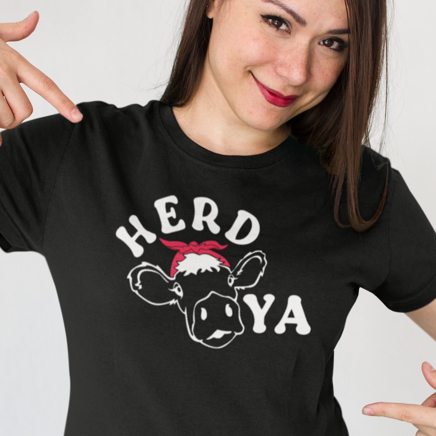 herd-ya-black-t-shirt-cowgirl-smiling-customer-showing-her-new-tee-mockup-against-a-white-background
