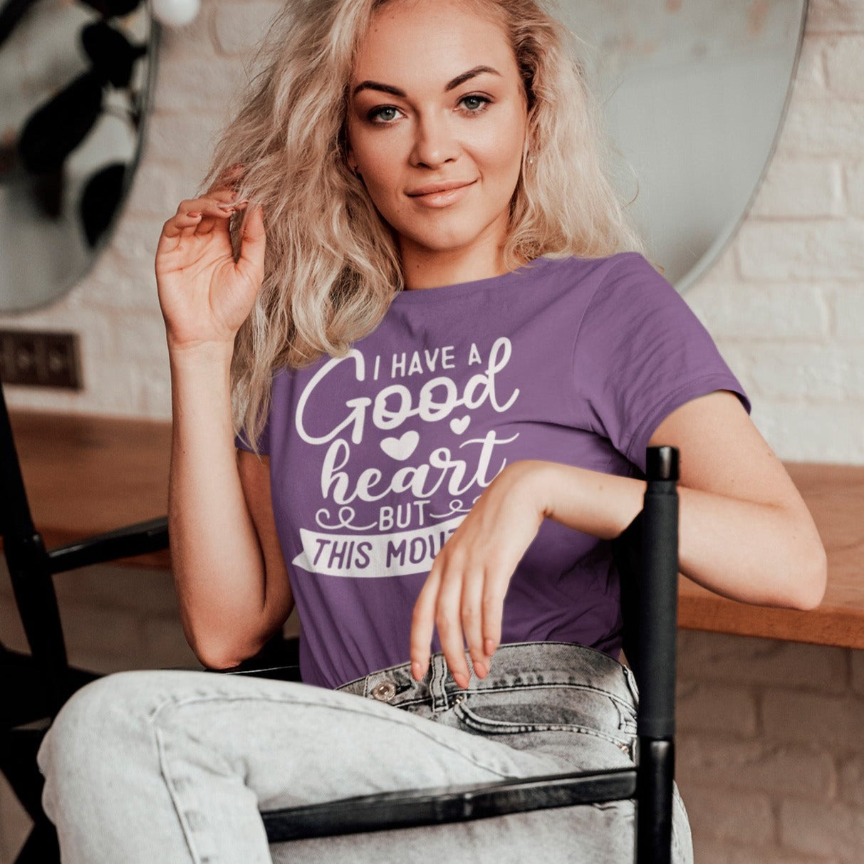 i-have-a-good-heart-but-this-mouth-team-purple-t-shirt-women-sarcastic-funny-mockup-of-a-woman-posing-on-a-chair