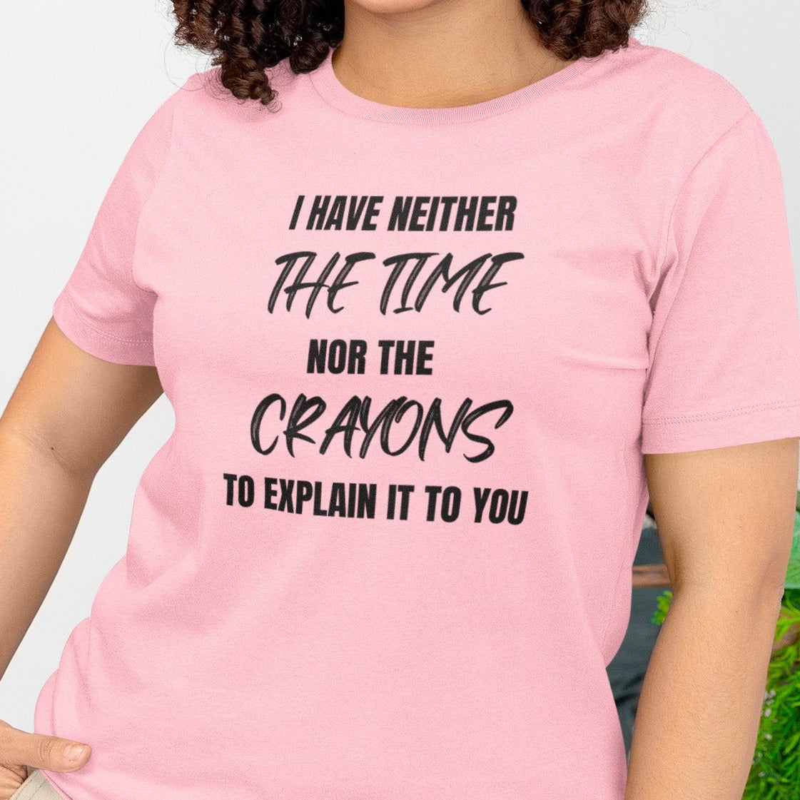 i-have-neither-the-time-nor-the-crayons-to-explain-it-to-you-pink-bella-canvas-t-shirt-mockup-featuring-a-smiling-woman-with-curly-hair