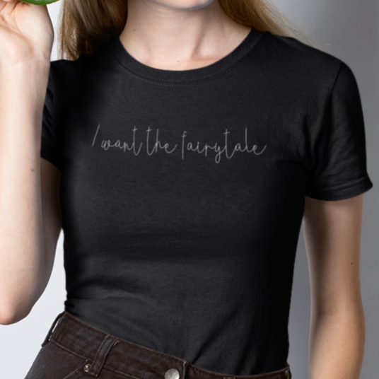 i-want-the-fairytale-black-t-shirt-mockup-of-a-fashionable-girl-holding-a-leaf-against-her-face