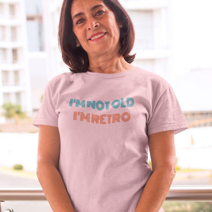 im-not-old-im-retro-pink-t-shirt-portrait-of-an-elder-woman-wearing-a-tee-mockup-holding-a-bag