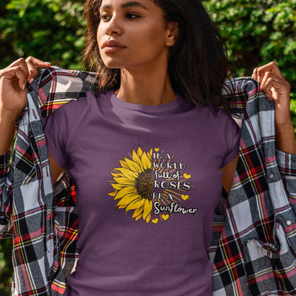 in-a-world-full-of-roses-be-a-sunflower-team-purple-t-shirt-womens-mockup-of-a-young-woman-standing-in-front-of-a-green-wall