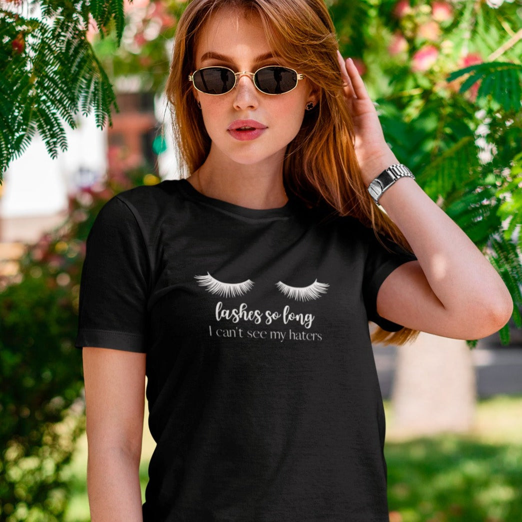 lashes-so-long-i-cant-see-my-haters-black-t-shirt-womens-mockup-of-a-woman-under-the-shadow-of-a-floral-tree