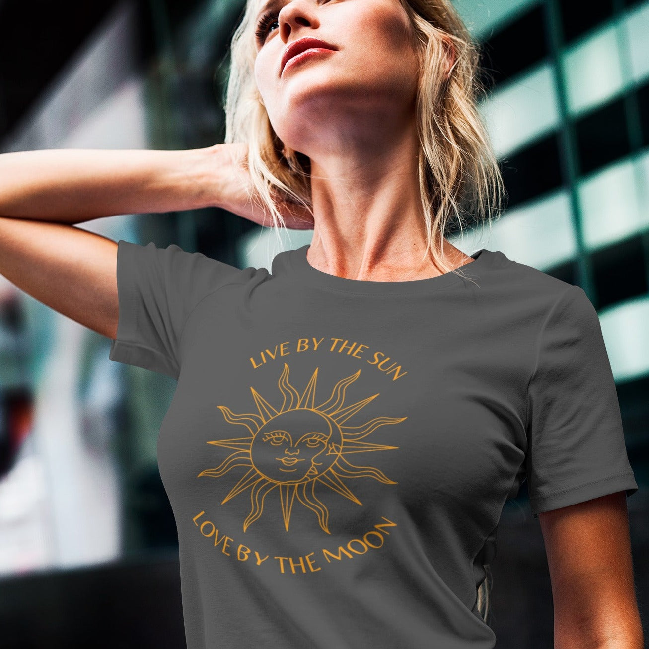 live-by-the-sun-love-by-the-moon-asphalt-t-shirt-with-sun-and-moon-design-mockup-featuring-a-woman-posing-on-a-city-street