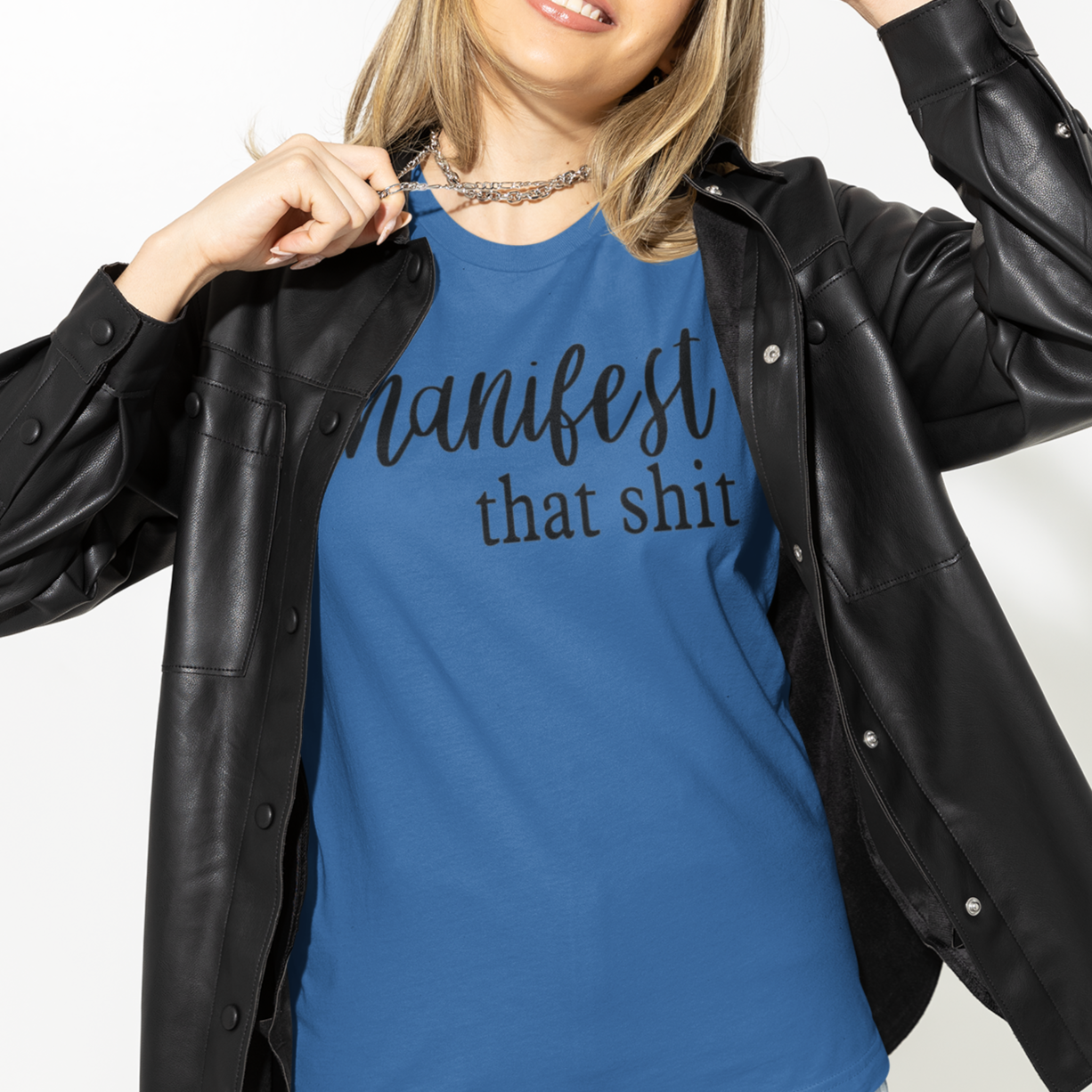 manifest-that-shit-true-royal-blue-t-shirt-womens-tee-bella-canvas-mockup-of-a-woman-in-a-studio-wearing-a-leather-jacket