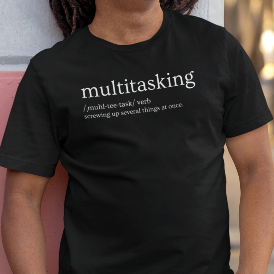 multitasking-screwing-up-several-things-at-once-black-t-shirt-bella-canvas-tee-mockup-of-a-happy-man-leaning-against-a-wall