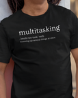 multitasking-screwing-up-several-things-at-once-black-t-shirt-bella-canvas-tee-mockup-of-a-happy-man-leaning-against-a-wall