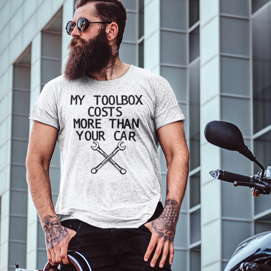 my-toolbox-cost-more-than-your-car-t-shirt-mockup-of-a-man-with-a-thick-beard-posing-next-to-a-motorbike