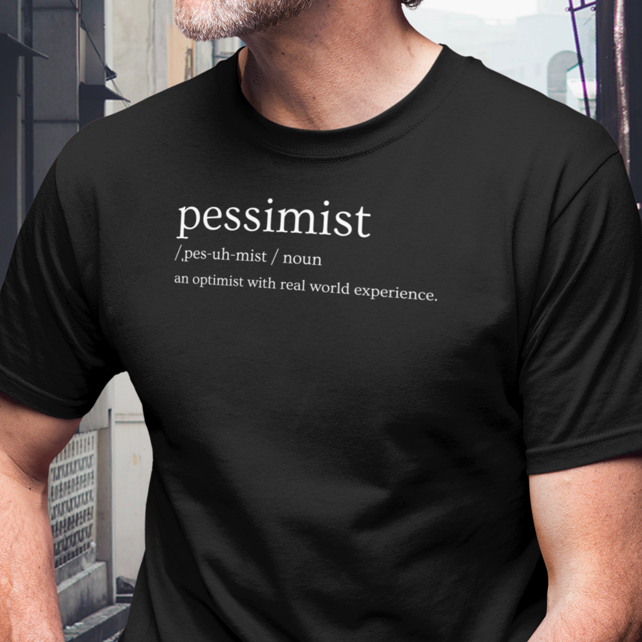 pessimist-an-optimist-with-real-world-experience-black-t-shirt-mockup-of-the-closeup-of-a-bearded-man-wearing-a-tee