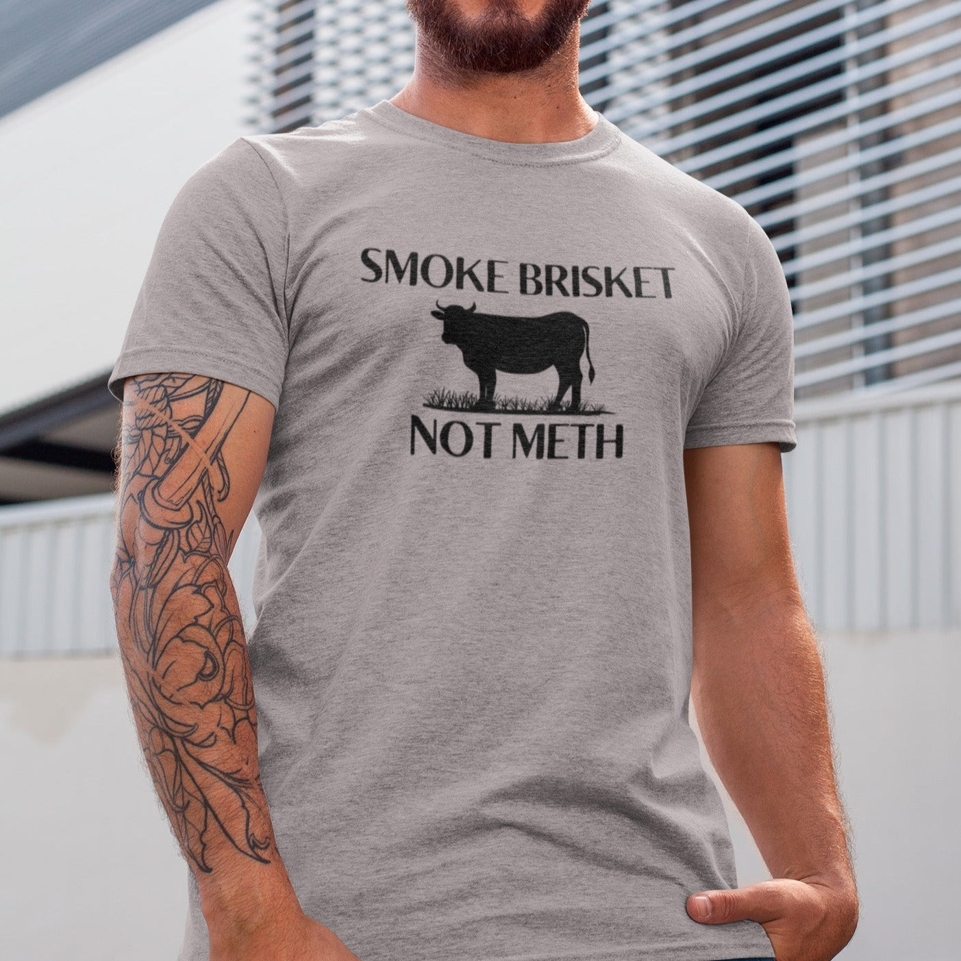 smoke-brisket-not-meth-athletic-heather-grey-t-shirt-funny-cow-tee-mockup-of-a-tattooed-man-smiling