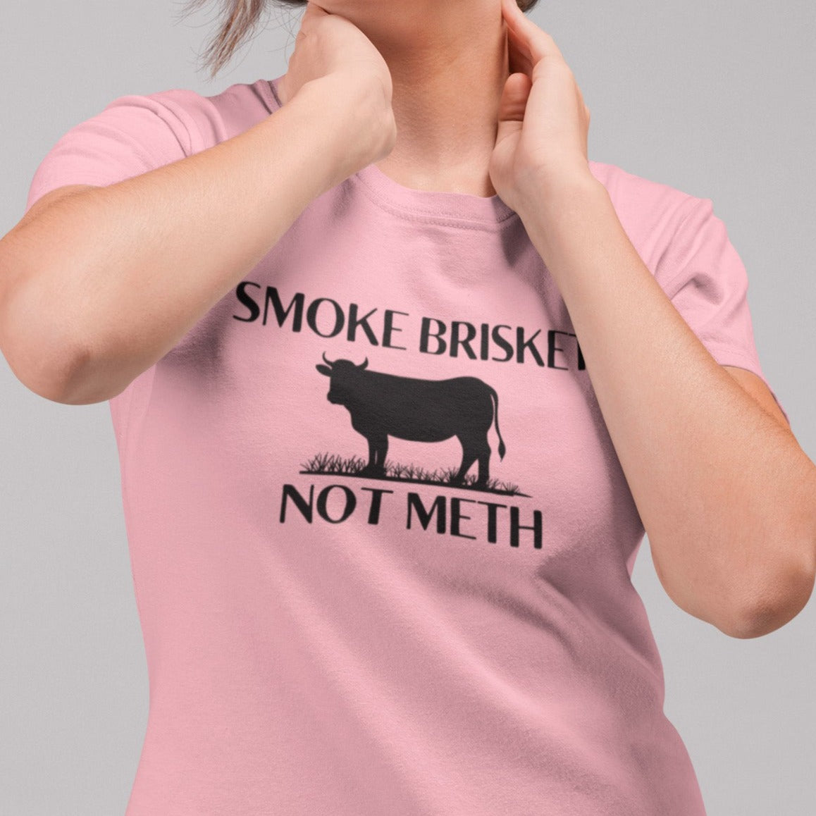 smoke-brisket-not-meth-pink-t-shirt-funny-cow-mockup-featuring-a-woman-wearing-a-round-neck-tshirt-while-at-a-studio