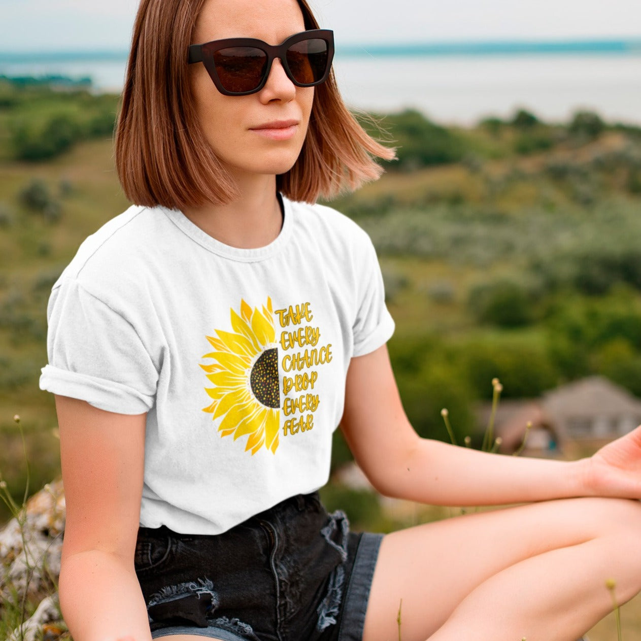 take-every-chance-drop-every-fear-white-t-shirt-sunflower-mockup-of-a-woman-meditating-after-a-hike