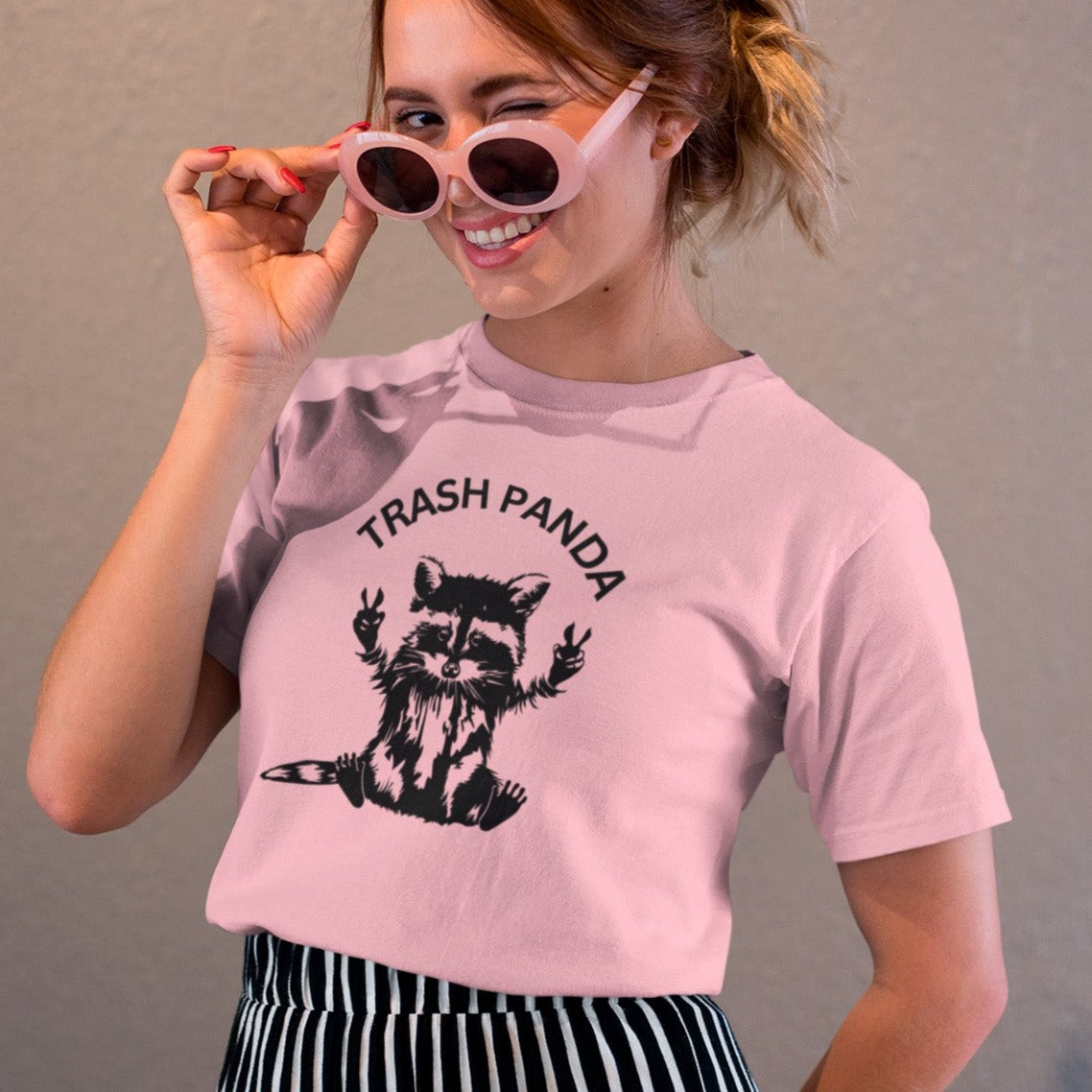 trash-panda-racoon-pink-t-shirt-unisex-tee-mockup-of-a-girl-with-cool-sunglasses-winking