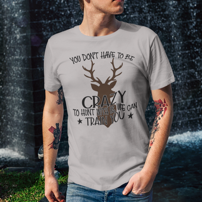 ou-dont-have-to-be-crazy-to-hunt-with-us-we-can-train-you-athletic-heather-grey-t-shirt-mockup-of-a-cool-man-walking-by-a-fountain
